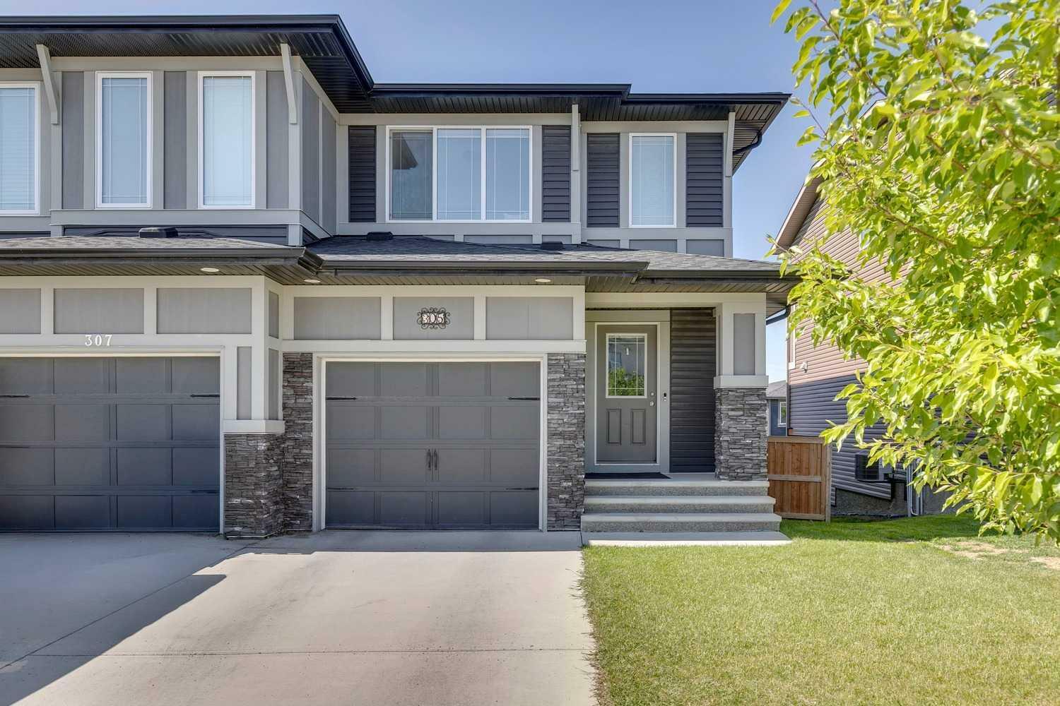 Property Photo: 305 Heartland Crescent AB T4C 2P7
