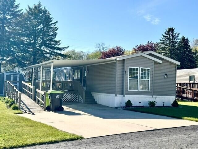 Property Photo:  411 Woodview Drive  MI 48838 